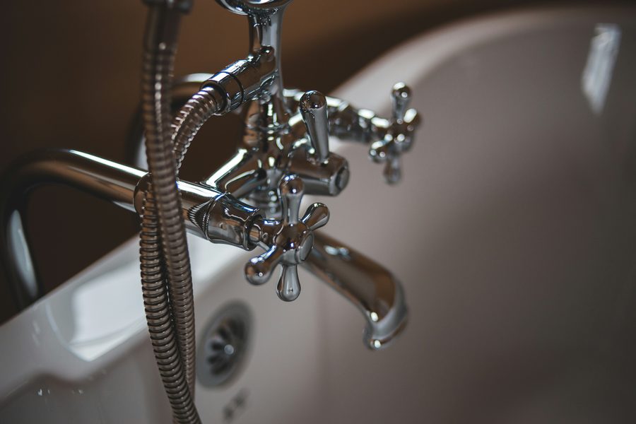 Chrome tub and shower valve with cross handles on a bath